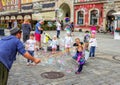 Street entertainer Ã¢â¬â playing with children, making soap bubbles